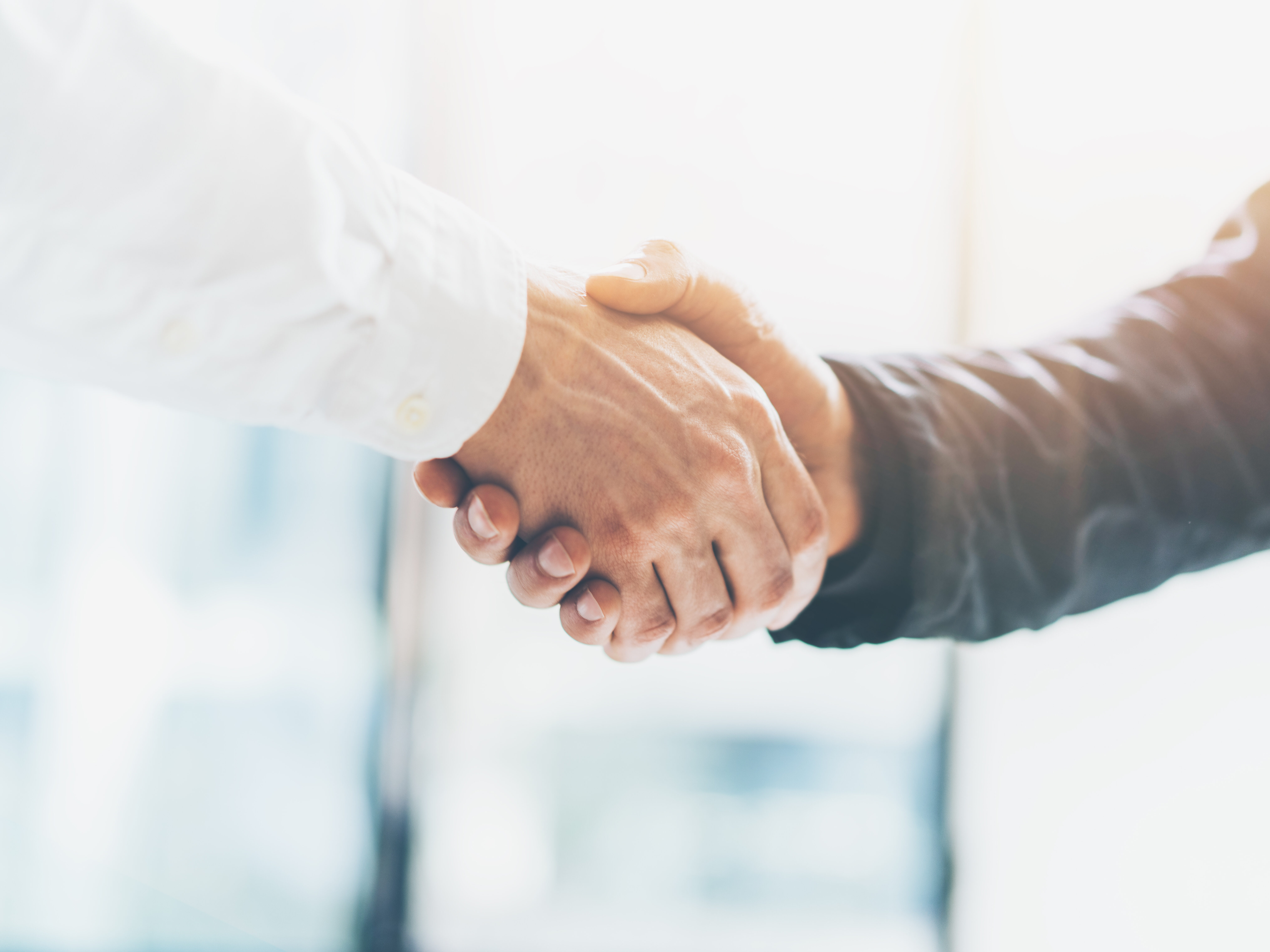 Business partnership meeting. Picture businessmans handshake. Successful businessmen handshaking after good deal. Horizontal, blurred background